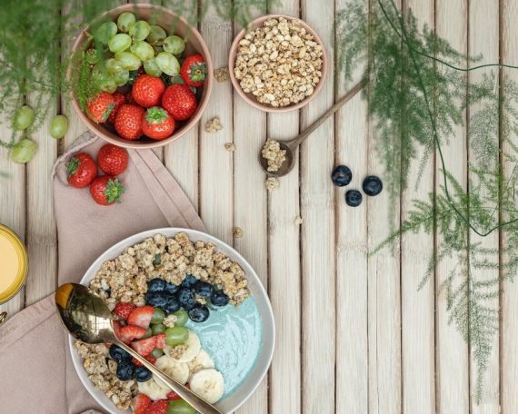 a table topped with bowls of fruit and cereal